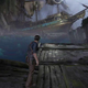 Nathan Drake stands in a dark, water-filled cave before a very large pirate ship in Uncharted 4.